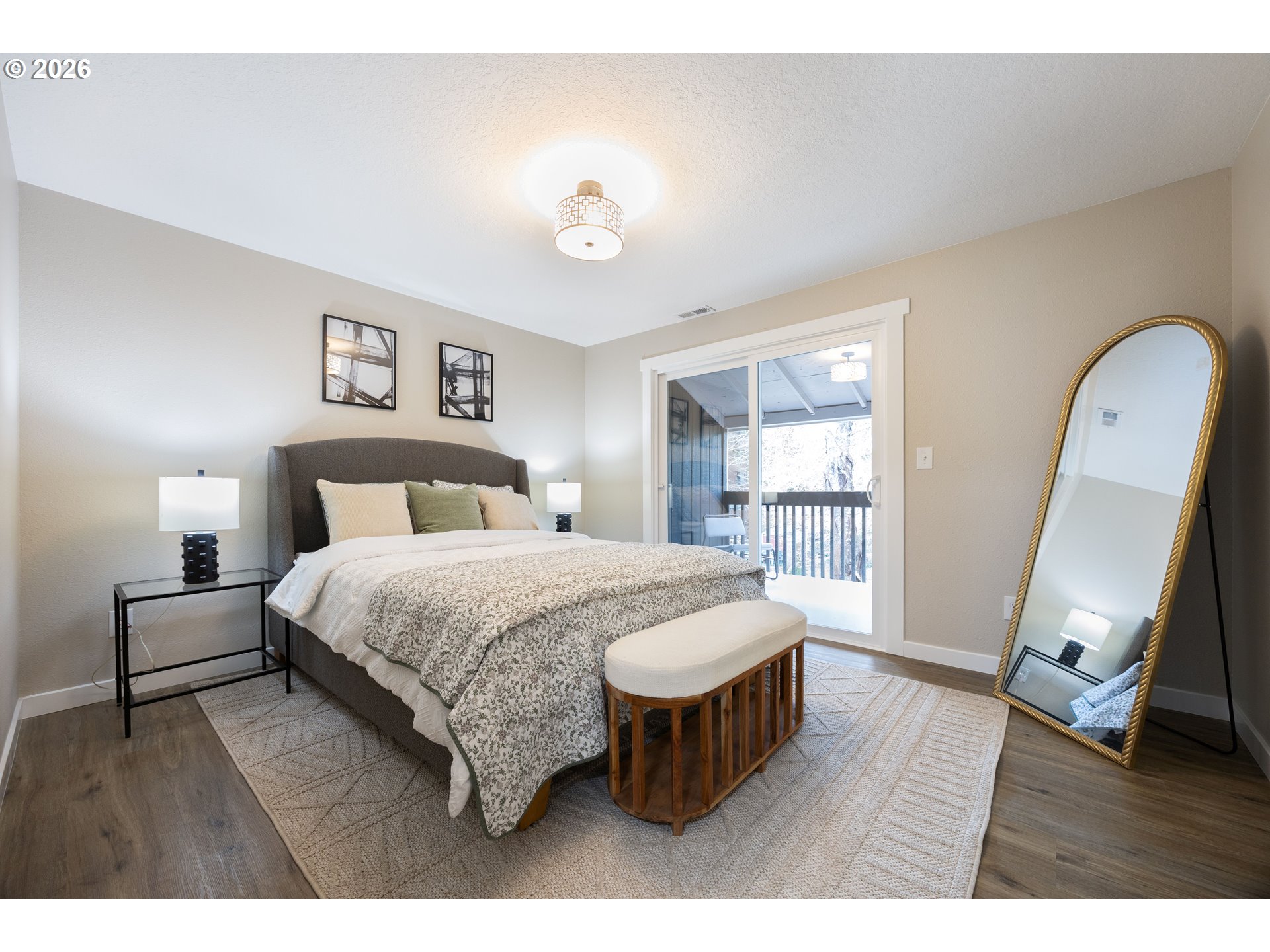 4921 Southwest 59th Avenue, Unit 6 Portland, OR 97221 - Photo 10 of 23 a bedroom with a bed a mirror on dresser and a window