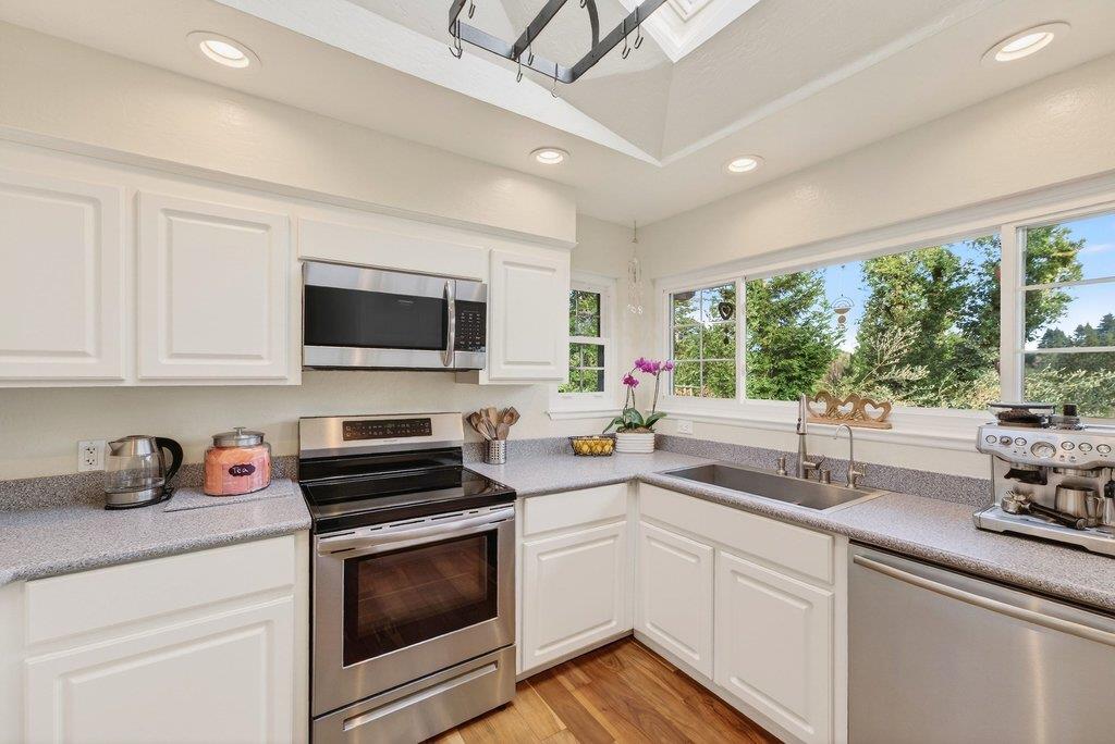 2907 Granite Creek Road Scotts Valley, CA 95066 - Photo 15 of 68 a kitchen with stainless steel appliances a stove sink microwave and cabinets