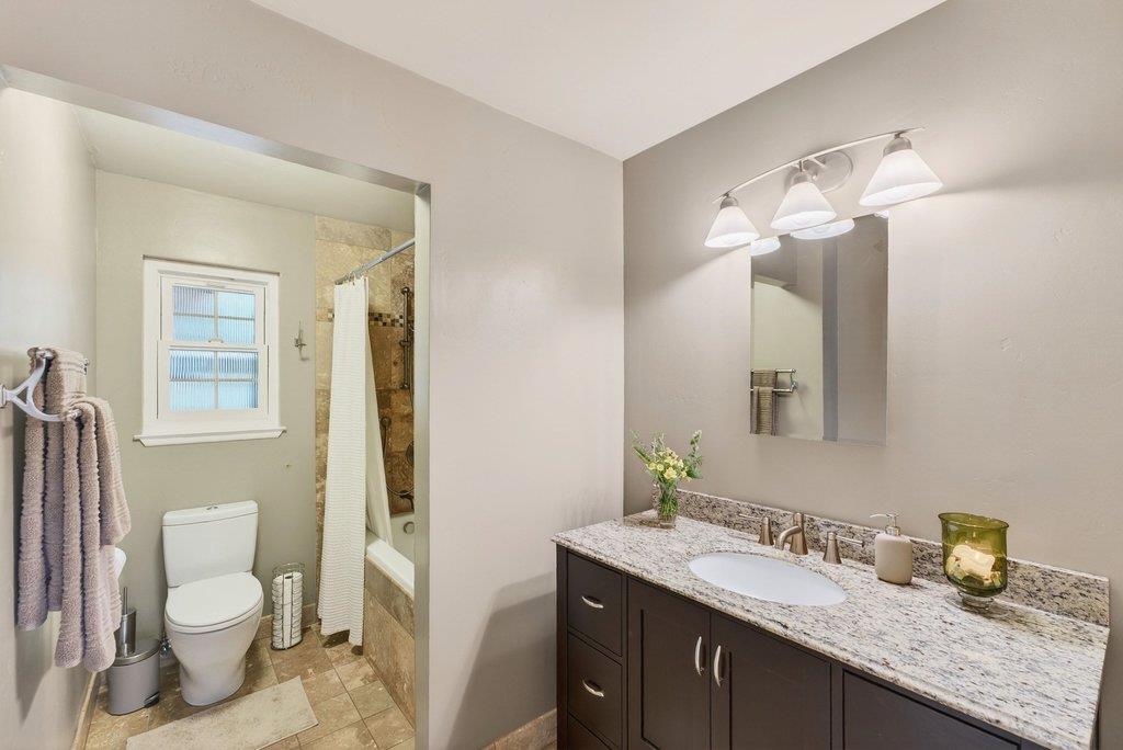 2907 Granite Creek Road Scotts Valley, CA 95066 - Photo 32 of 68 a bathroom with a granite countertop sink toilet and mirror