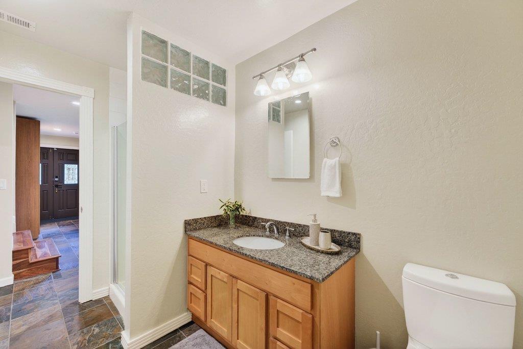 2907 Granite Creek Road Scotts Valley, CA 95066 - Photo 43 of 68 a bathroom with a granite countertop sink and a mirror