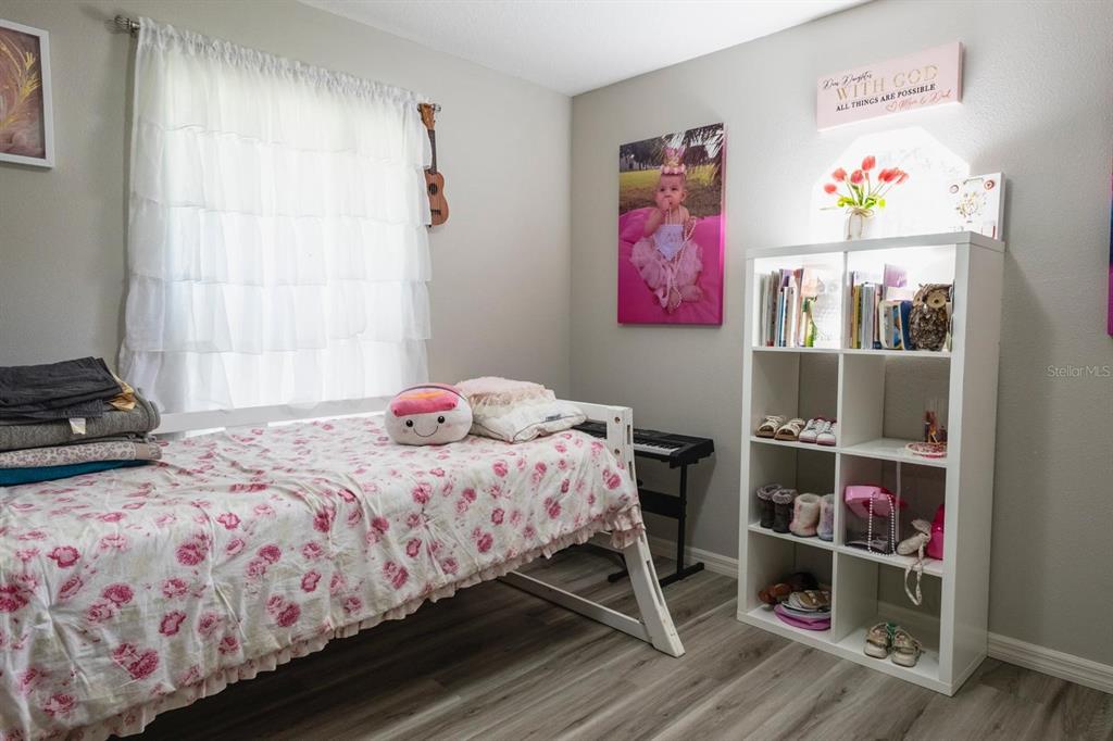 12569 Southwest 73rd Street Ocala, FL 34481 - Photo 11 of 28 a bedroom with a bed and a window