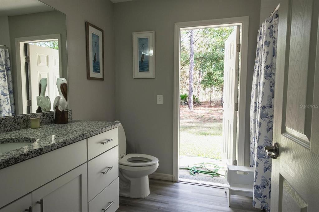 12569 Southwest 73rd Street Ocala, FL 34481 - Photo 13 of 28 a bathroom with a granite countertop sink toilet and mirror