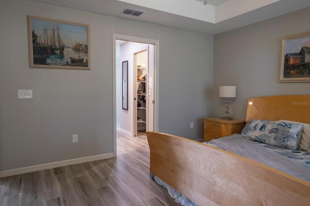 12569 Southwest 73rd Street Ocala, FL 34481 - Photo 18 of 28 a bedroom with a bed and painting on the wall