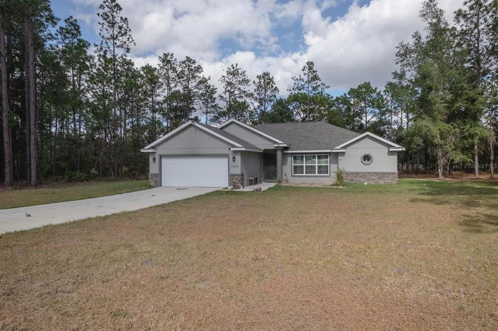 12569 Southwest 73rd Street Ocala, FL 34481 - Photo 23 of 28 a house with trees in the background