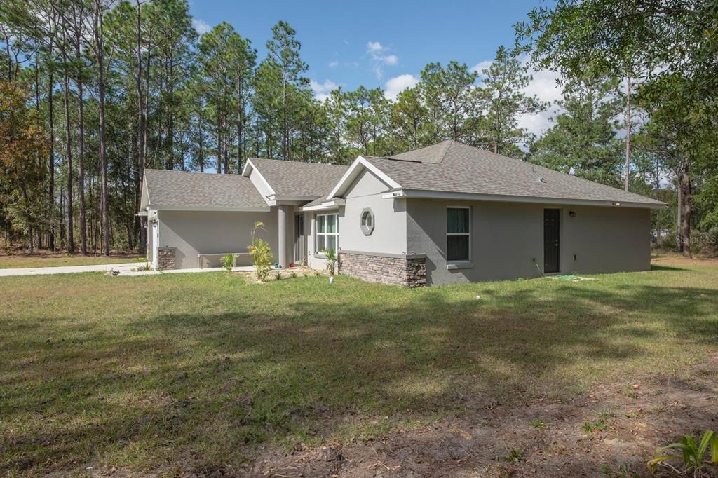 12569 Southwest 73rd Street Ocala, FL 34481 - Photo 24 of 28 a view of a house with a yard