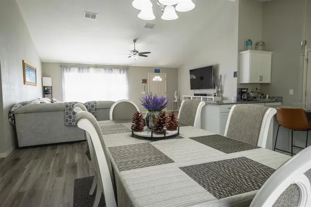 a living room with furniture a flat screen tv and a large window