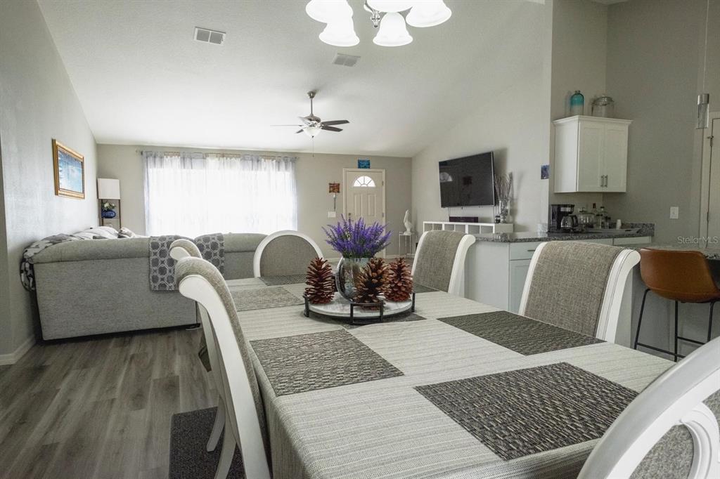 12569 Southwest 73rd Street Ocala, FL 34481 - Photo 8 of 28 a living room with furniture a flat screen tv and a large window