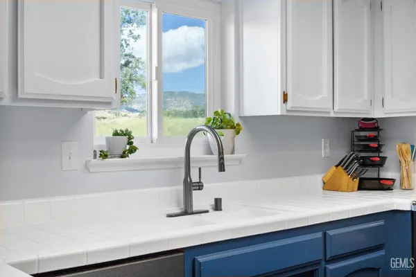 a kitchen with stainless steel appliances granite countertop a stove and a cabinets