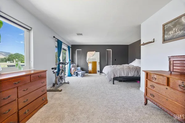 a spacious bedroom with a bed and a table in it