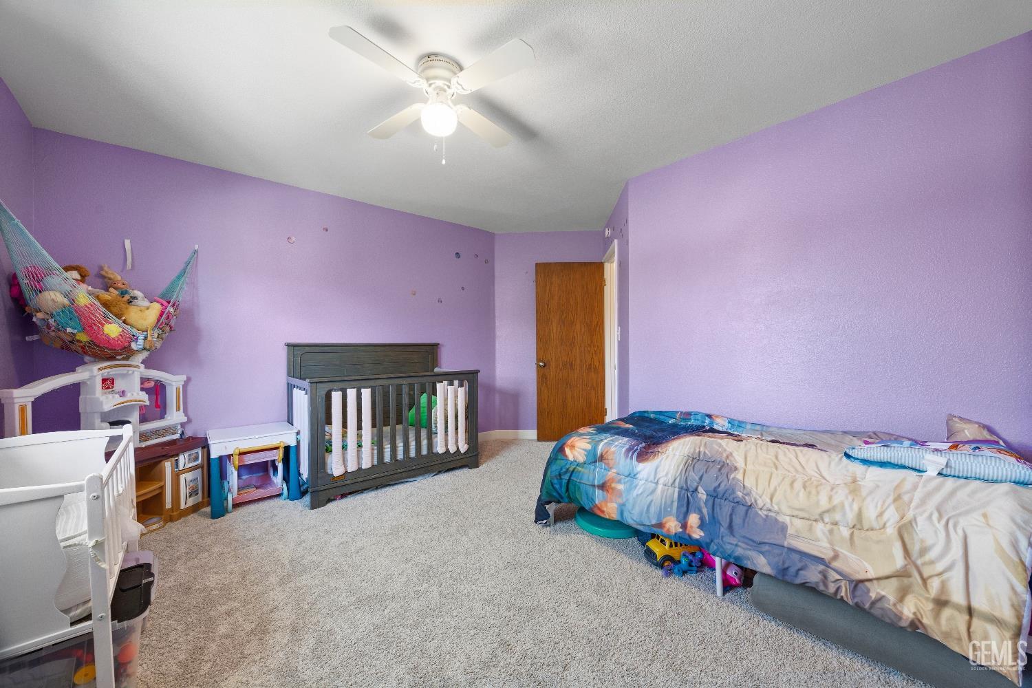 Undisclosed Address Tehachapi, CA 93561 - Photo 24 of 46 a bedroom with a bed and a chandelier