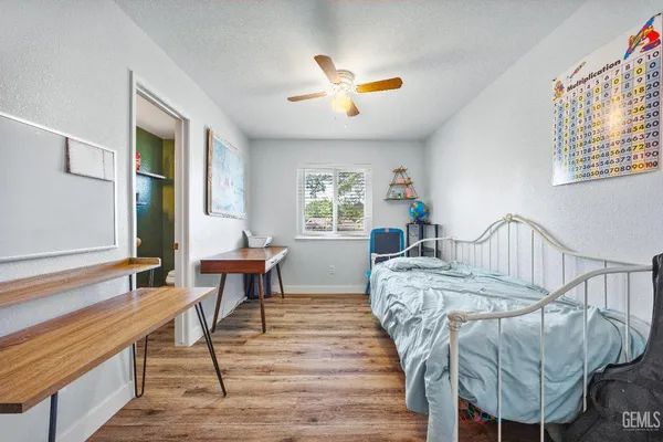 a spacious bedroom with a bed and a table in it
