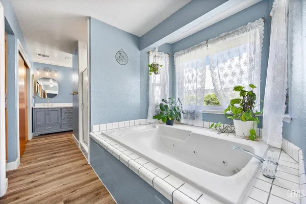 a bathroom with a double vanity sink and a mirror