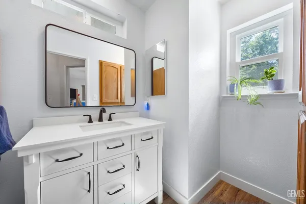 a bathroom with a sink a mirror and shower