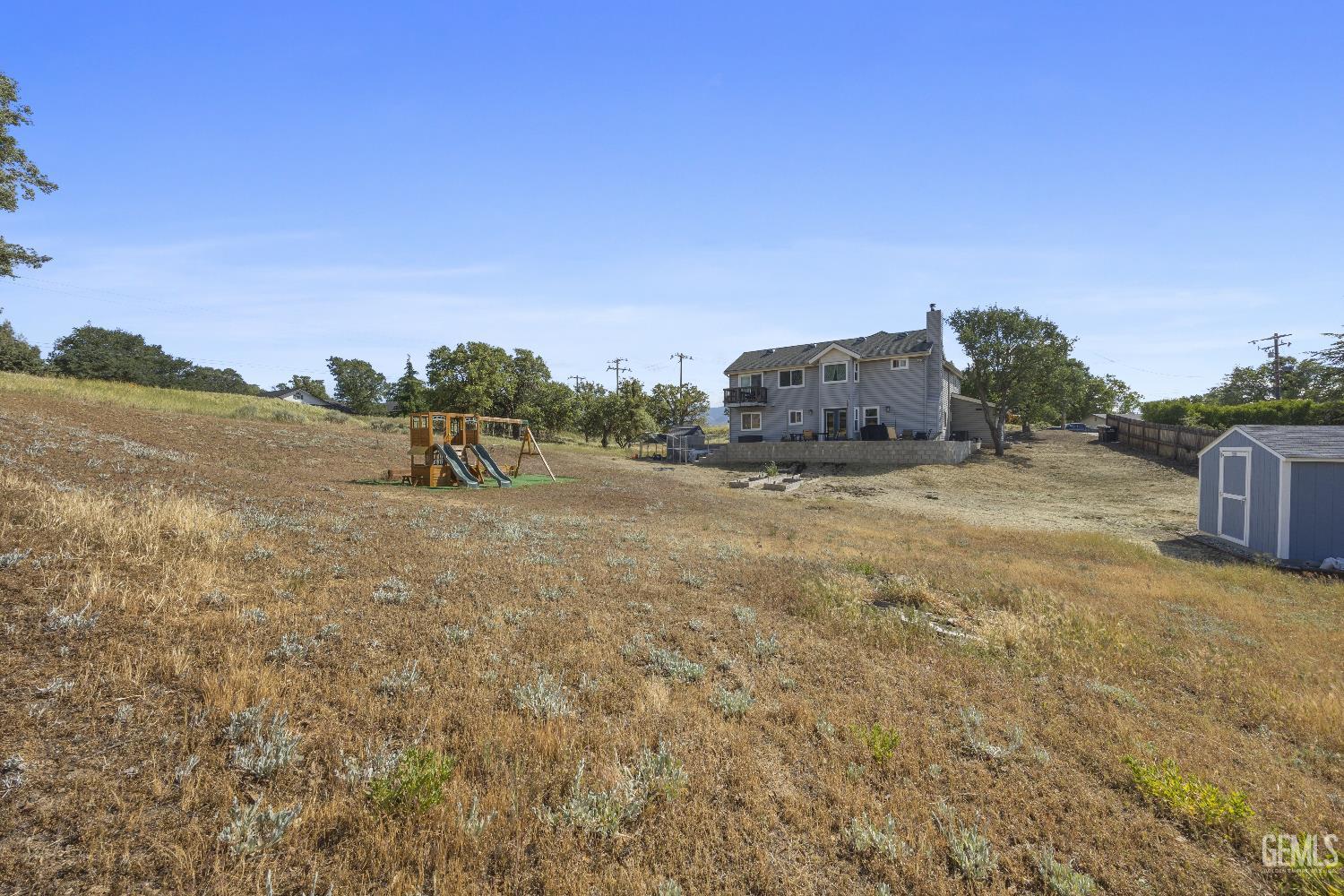 Undisclosed Address Tehachapi, CA 93561 - Photo 45 of 46 a view of a dry yard with trees in the background
