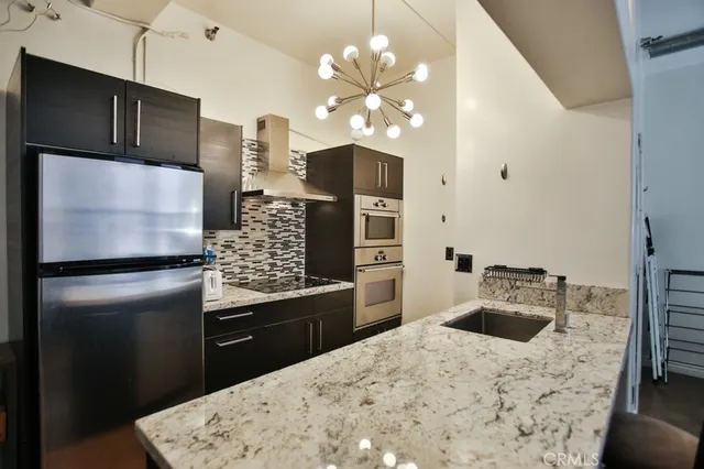 a kitchen with a refrigerator and a sink