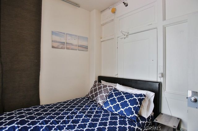 a bedroom with a bed and a black walk in closet