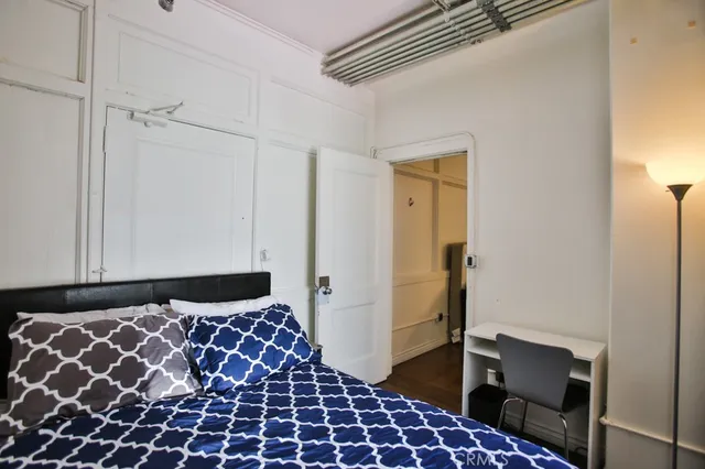 a bathroom with a sink and mirror with bathtub
