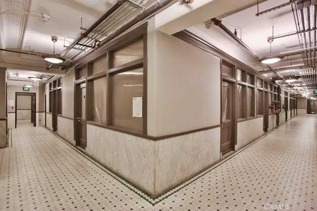 a view of a hallway with wooden shelves