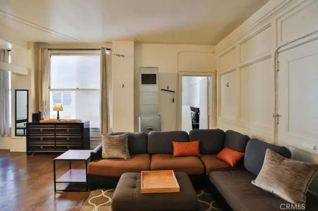 a living room with furniture and wooden floor