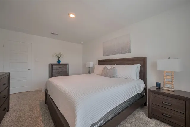 a bedroom with a bed and with furniture