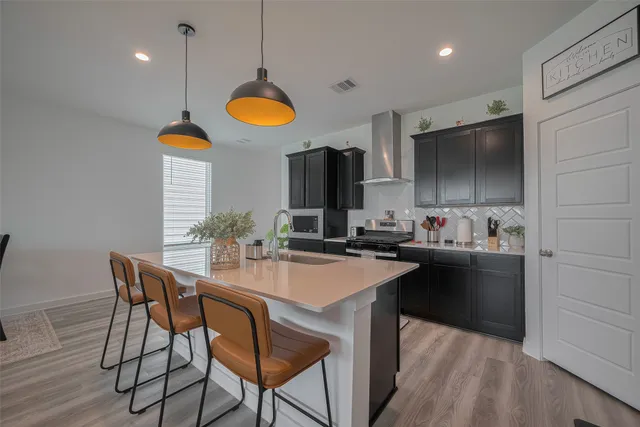 a kitchen with a table chairs sink and microwave