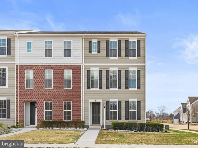 a front view of a building with a yard