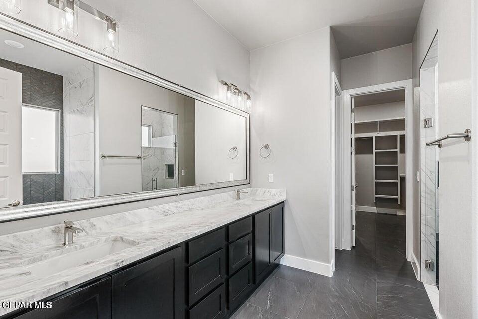7353 Cimarron Rim Road El Paso, TX 79911 - Photo 15 of 30 a bathroom with a double vanity sink and a mirror