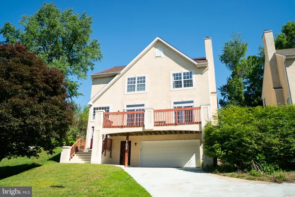 a view of a house with a yard and potted plants