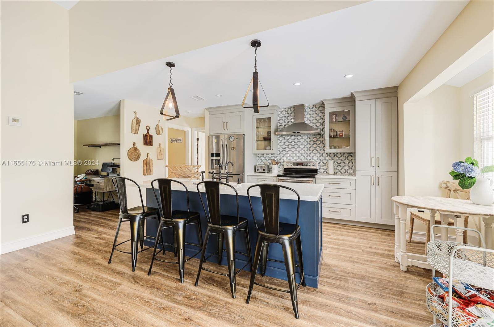 14871 Southwest 156th Street Miami, FL 33187 - Photo 22 of 84 a view of a dining room with furniture and wooden floor