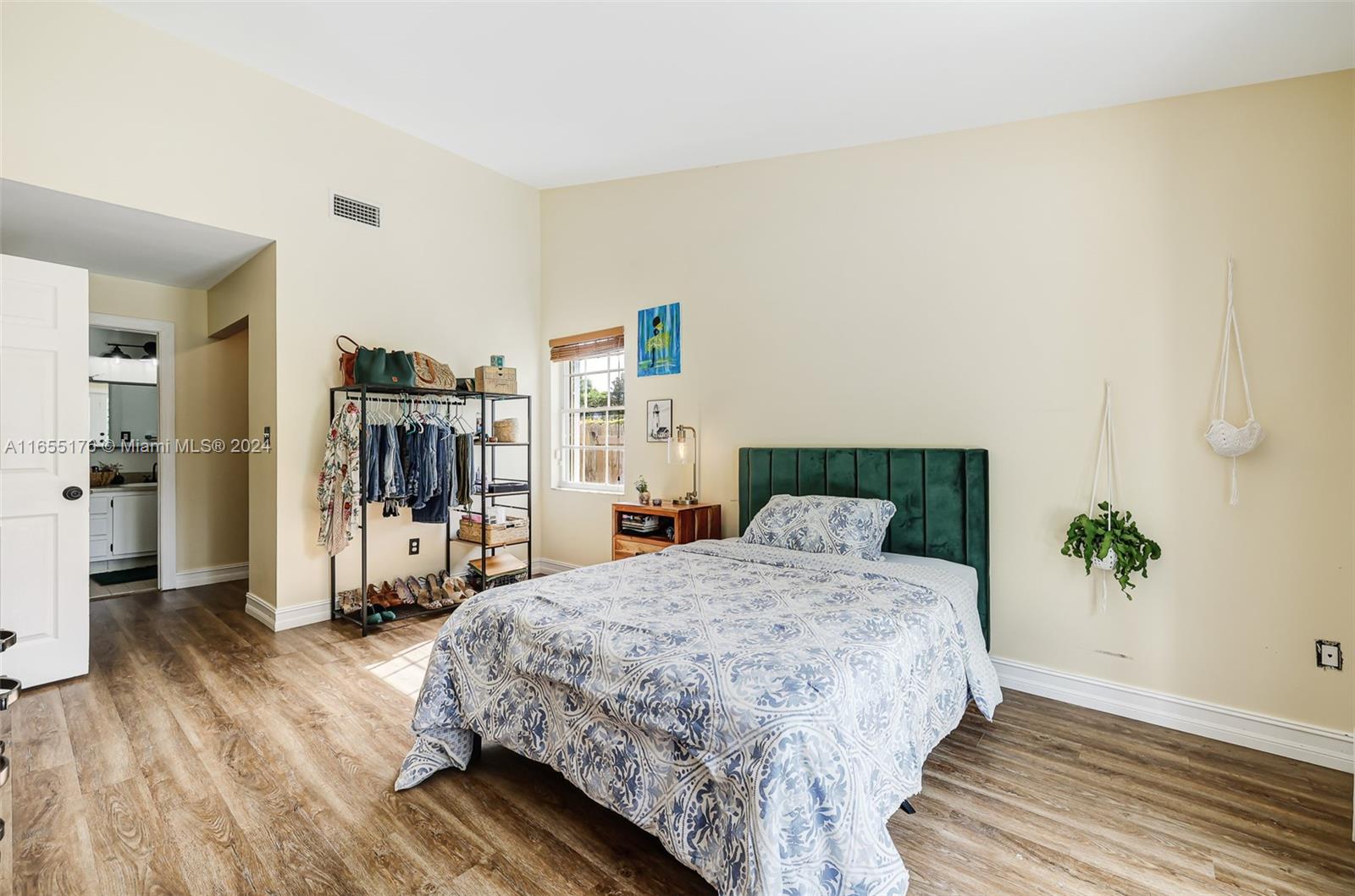 14871 Southwest 156th Street Miami, FL 33187 - Photo 28 of 84 a bedroom with a bed and a wooden floor