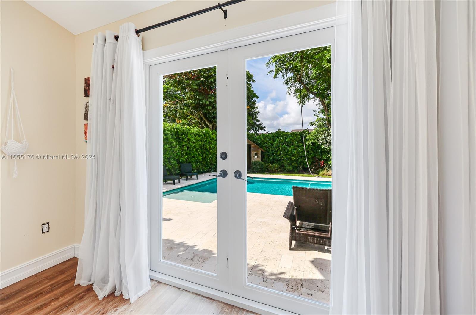 14871 Southwest 156th Street Miami, FL 33187 - Photo 29 of 84 a view of a porch with furniture and garden