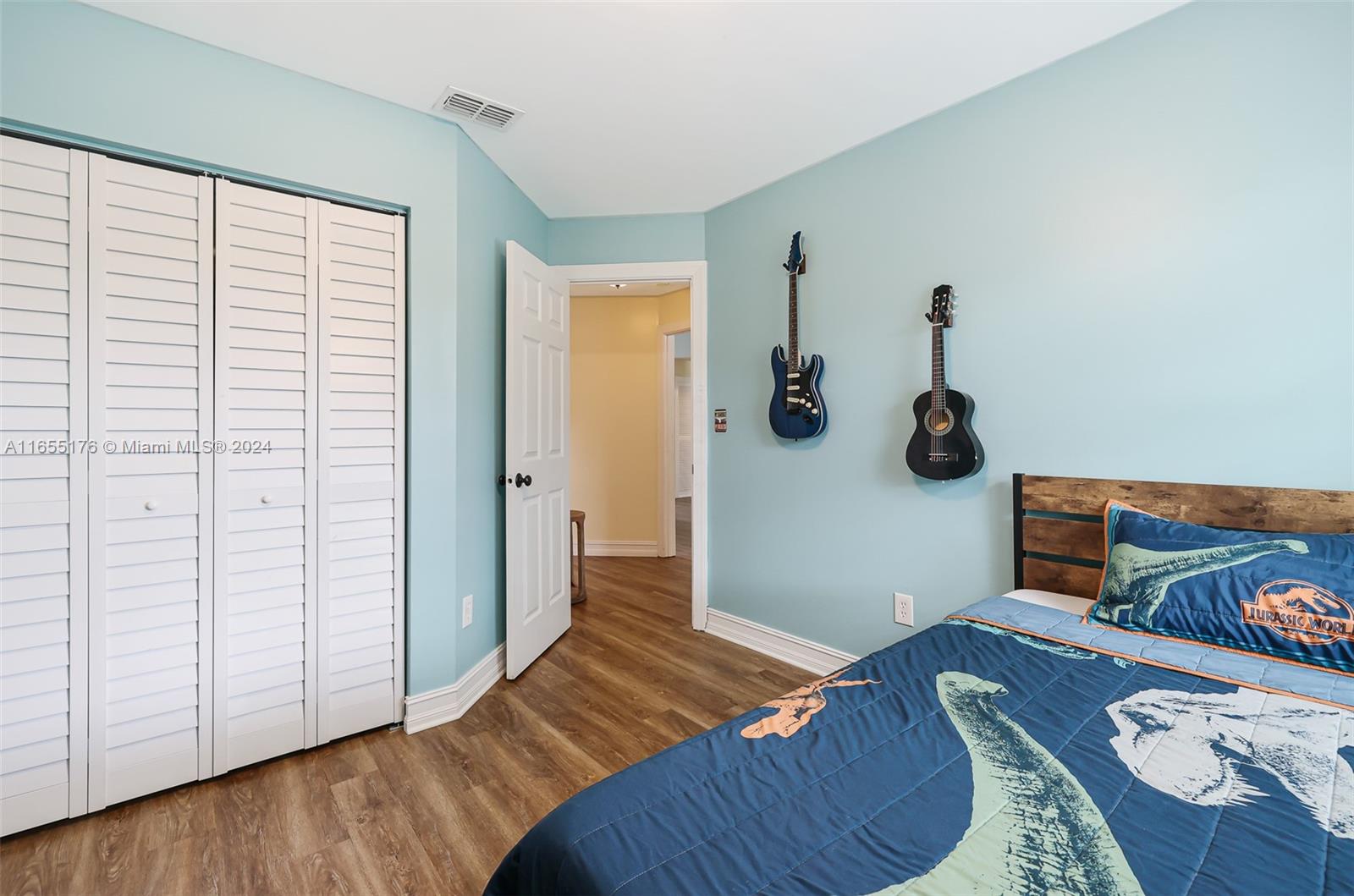 14871 Southwest 156th Street Miami, FL 33187 - Photo 35 of 84 a bedroom with a bed and a wooden floor