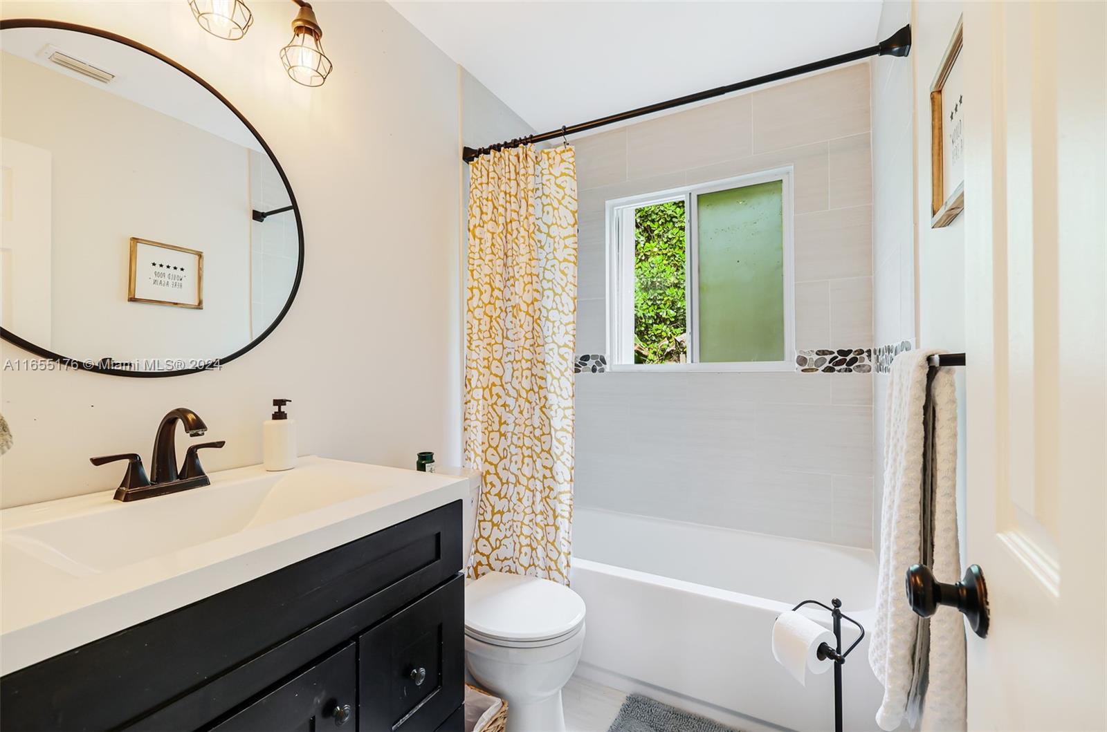 14871 Southwest 156th Street Miami, FL 33187 - Photo 39 of 84 a bathroom with a sink a toilet and a mirror
