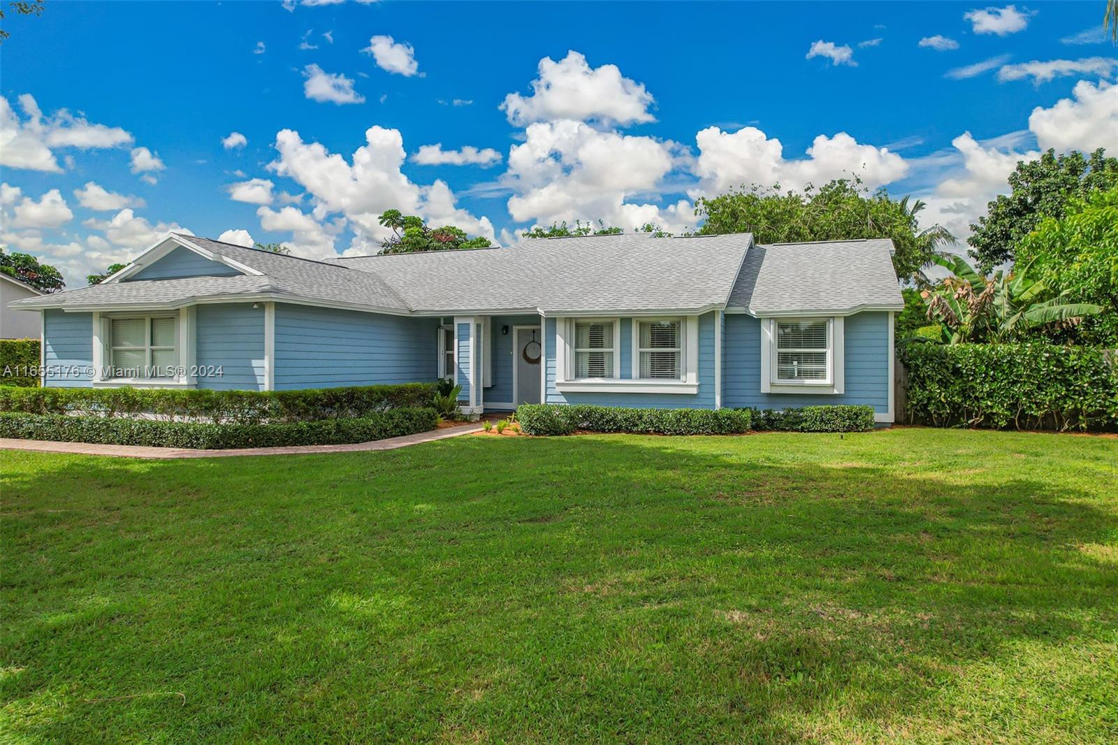 14871 Southwest 156th Street Miami, FL 33187 - Photo 4 of 84 a front view of a house with a garden