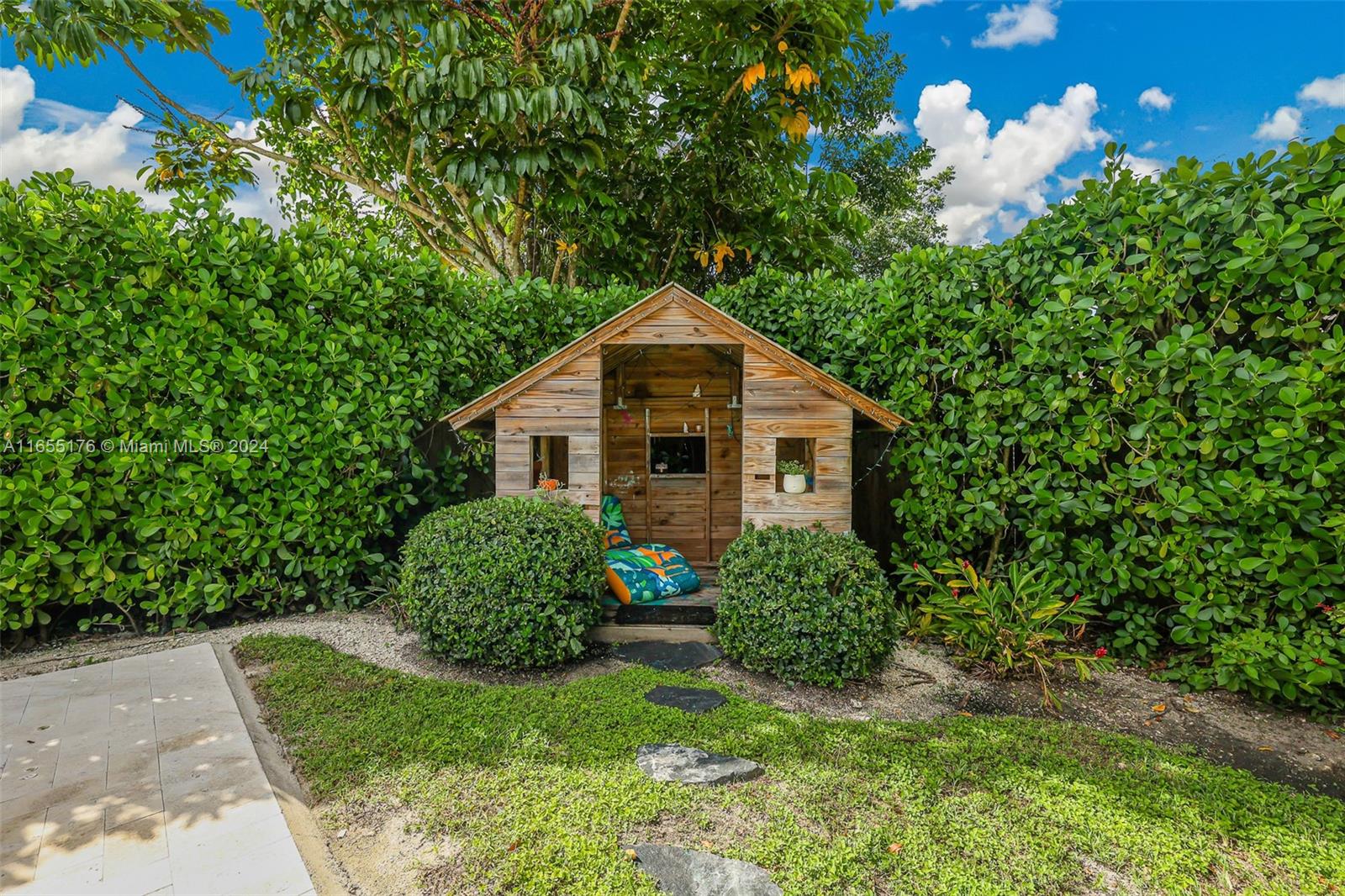 14871 Southwest 156th Street Miami, FL 33187 - Photo 49 of 84 a yellow and red house with a big yard and large trees
