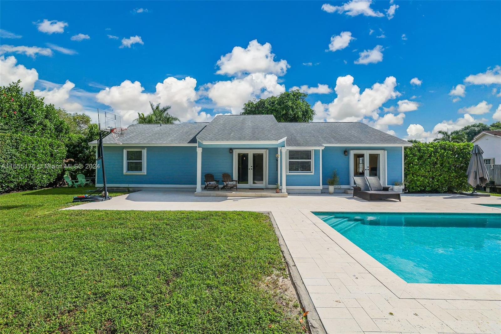 14871 Southwest 156th Street Miami, FL 33187 - Photo 51 of 84 a front view of a house with swimming pool having outdoor seating