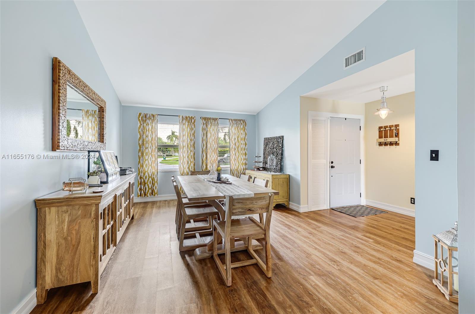 14871 Southwest 156th Street Miami, FL 33187 - Photo 8 of 84 a view of a dining room with furniture and wooden floor