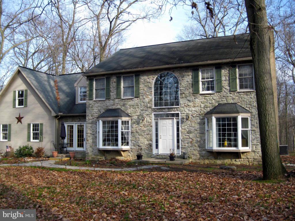 159 1/2 Wesley Road Quarryville, PA 17566 - Photo 1 of 43 a front view of a house with a garden