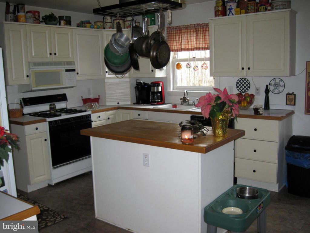 159 1/2 Wesley Road Quarryville, PA 17566 - Photo 14 of 43 a kitchen with white cabinets and window