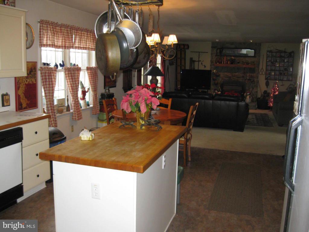 159 1/2 Wesley Road Quarryville, PA 17566 - Photo 16 of 43 a kitchen with a sink a counter space and chairs