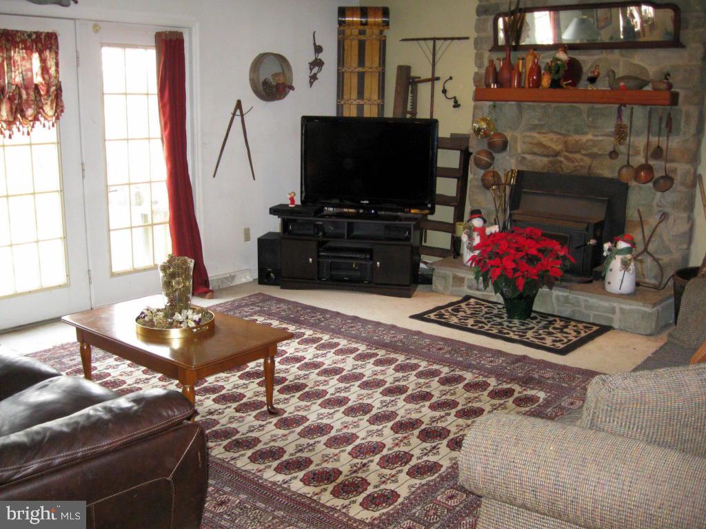 159 1/2 Wesley Road Quarryville, PA 17566 - Photo 21 of 43 a living room with furniture a flat screen tv and a fireplace