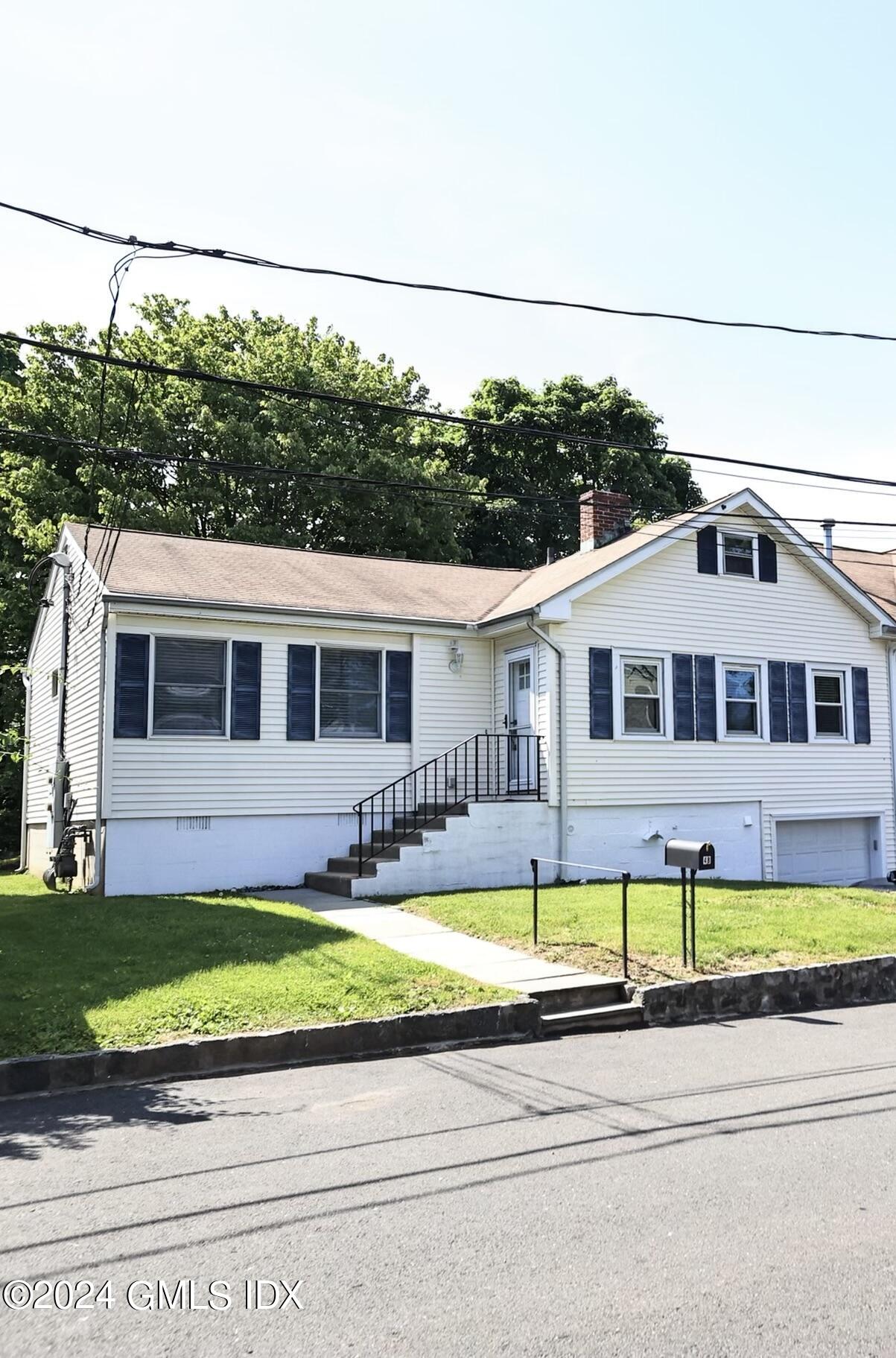 4 Silver Street, Unit B Greenwich, CT 06830 - Photo 1 of 24 a front view of a house with a big yard and potted plants