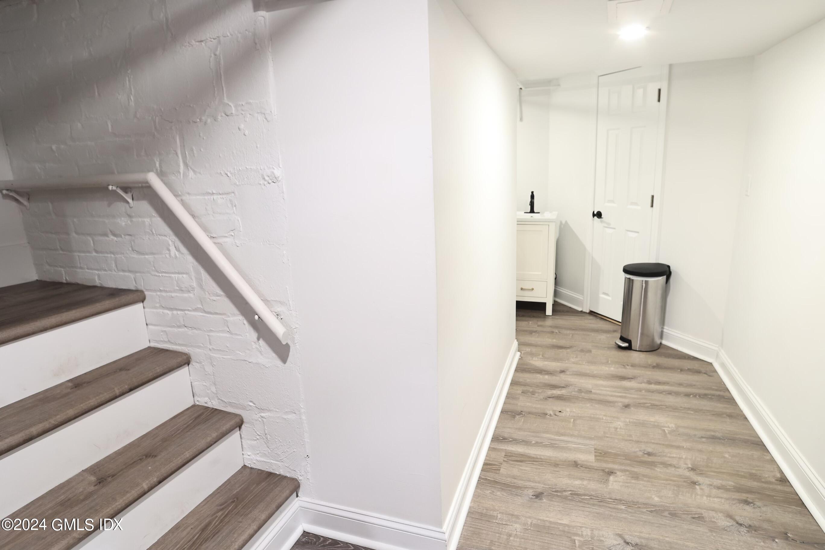 4 Silver Street, Unit B Greenwich, CT 06830 - Photo 18 of 24 a view of a hallway with wooden floor and staircase