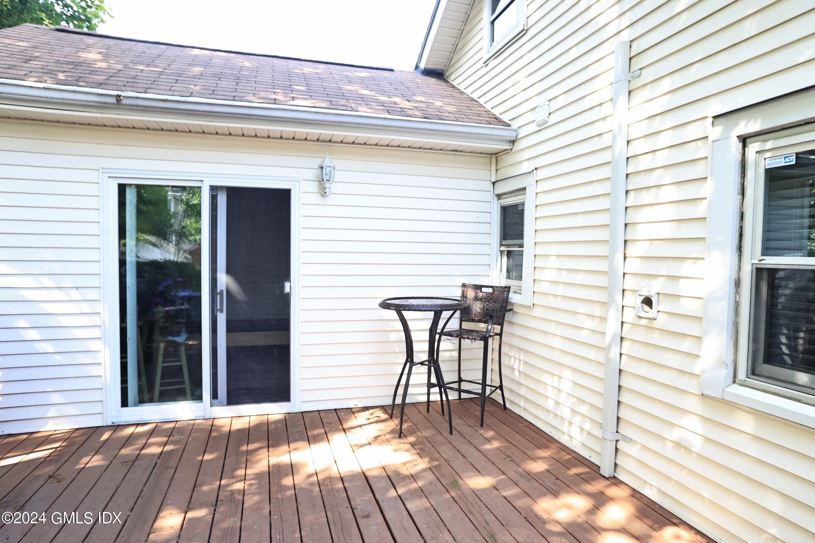 4 Silver Street, Unit B Greenwich, CT 06830 - Photo 23 of 24 a view of a patio with table and chairs with wooden floor and fence