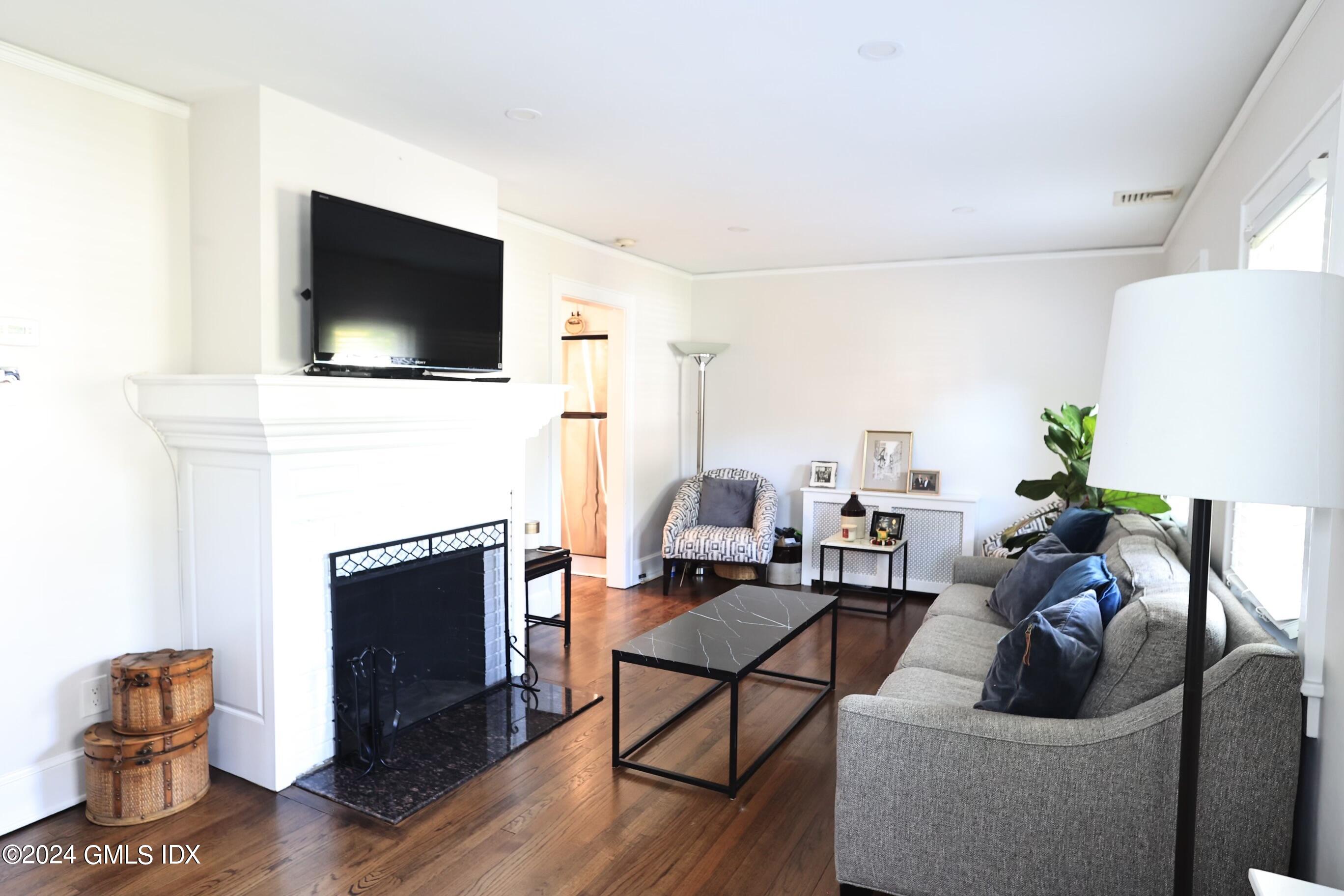 4 Silver Street, Unit B Greenwich, CT 06830 - Photo 3 of 24 a living room with furniture a flat screen tv and a fireplace