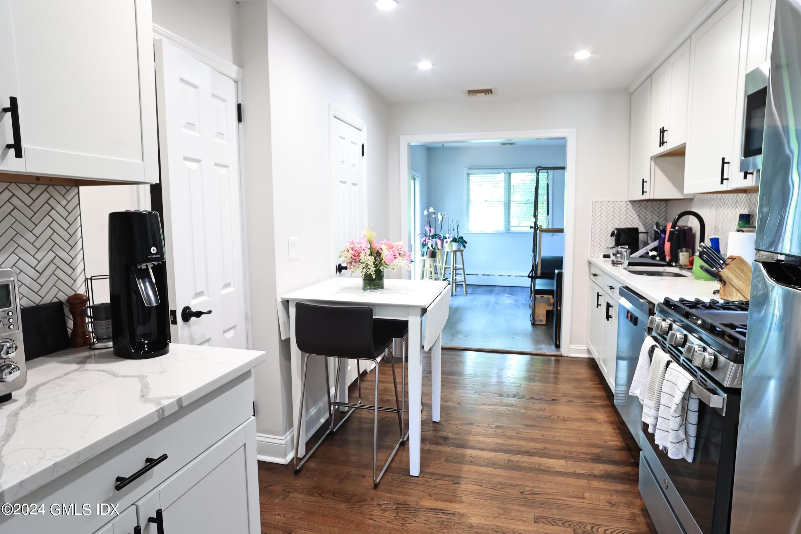 4 Silver Street, Unit B Greenwich, CT 06830 - Photo 8 of 24 a kitchen with a sink appliances and wooden floor
