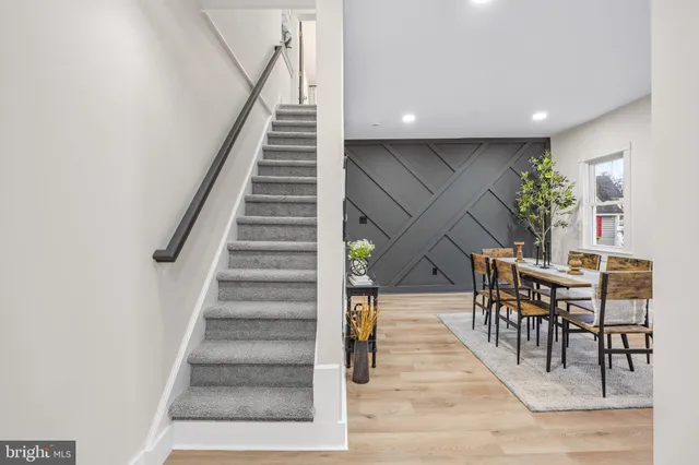 a view of entryway and hall with wooden floor