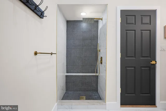 a bathroom with a granite countertop sink a toilet and shower