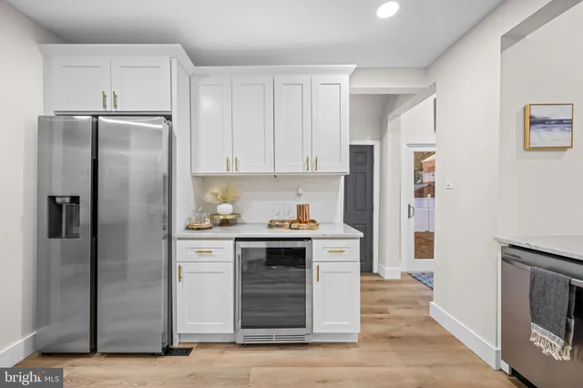 a kitchen with stainless steel appliances granite countertop a refrigerator and a stove top oven