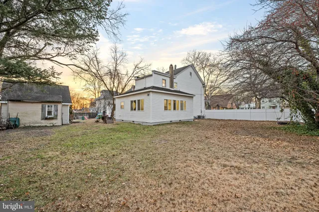 a view of a backyard with large trees